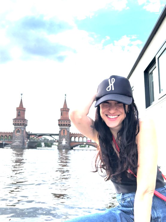 Sole smiling on a boat in front of the Oberbaum Bridge in Berlin